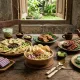 Kuliner legendaris di Purwokerto seperti Soto Sokaraja, Tempe Mendoan, Sate Bebek, Es Duren, dan Es Dawet Ayu di atas meja kayu